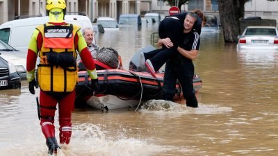 Rescue workers evacuate residents from a neighborhood after flash floods hit the southwestern Aude district of France after several months' worth of rain fell in just a few hours overnight, in Trebes