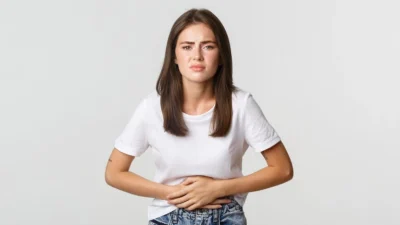 woman-having-stomach-ache-with-hands-belly-discomfort-from-menstrual-cramps-girl-feeling-nauseous-e1716838062674-768x477